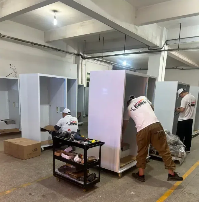 Sweet Robo team building custom vending machine cabinets on the factory floor